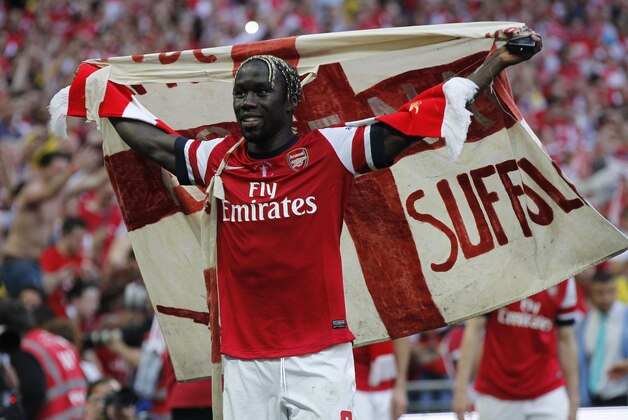 Arsenal's Bacary Sagna celebates their win against Hull City at the end of their English FA Cup final soccer match at Wembley Stadium in London, Saturday, May 17, 2014. (AP Photo/Sang Tan)