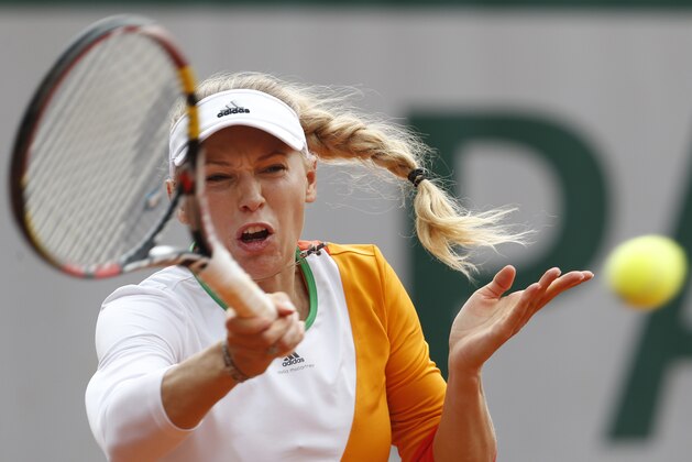 Denmark's Caroline Wozniacki returns the ball during the first round match of the French Open tennis tournament against Belgium's Yanina Wickmayer at the Roland Garros stadium, in Paris, France, Tuesday, May 27, 2014. (AP Photo/Darko Vojinovic)