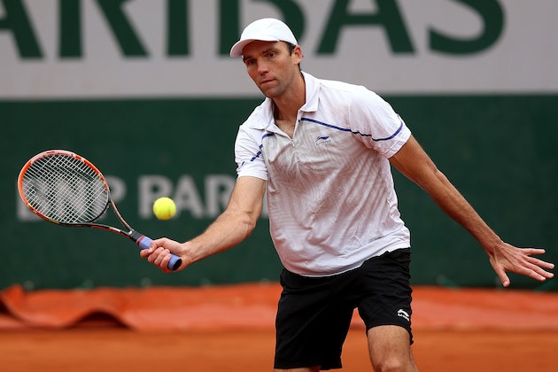 PARIS, FRANCE - MAY 27:  Ivo Karlovic of Croatia returns a shot in his men's singles match against Grigor Dimitrov of Bulgaria on day three of the French Open at Roland Garros on May 27, 2014 in Paris, France.  (Photo by Matthew Stockman/Getty Images)