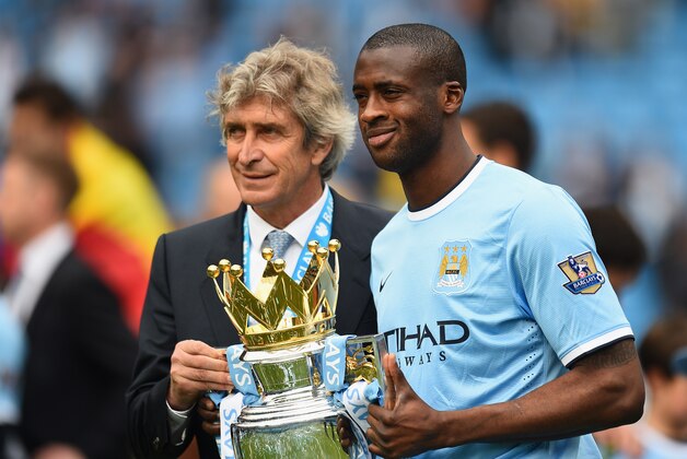 MANCHESTER, ENGLAND - MAY 11:  The Manchester City Manager Manuel Pellegrini and Yaya Toure pose with the trophy at the end of the Barclays Premier League match between Manchester City and West Ham United at the Etihad Stadium on May 11, 2014 in Manchester, England.  (Photo by Shaun Botterill/Getty Images)