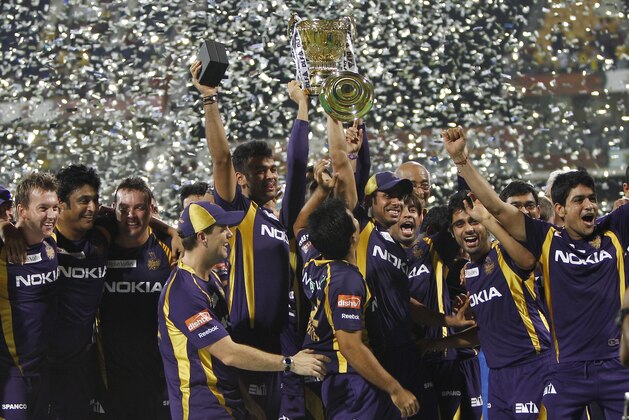 Players and support staff of Kolkata Knight Riders celebrate with the trophy after their win against Chennai Super Kings' in the Indian Premier League (IPL) final cricket match in Chennai, India, Sunday, May 27, 2012.  Kolkata Knight Riders won the match by five wickets. (AP Photo/Aijaz Rahi)