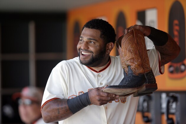 SAN FRANCISCO, CA - MAY 26:  Pablo Sandoval #48 of the San Francisco Giants holds up a pair of Madison Bumgarner's #40 cowboy boots in the dugout after hitting a home run in the fourth inning against the Chicago Cubs at AT&T Park on May 26, 2014 in San Francisco, California.  (Photo by Ezra Shaw/Getty Images)