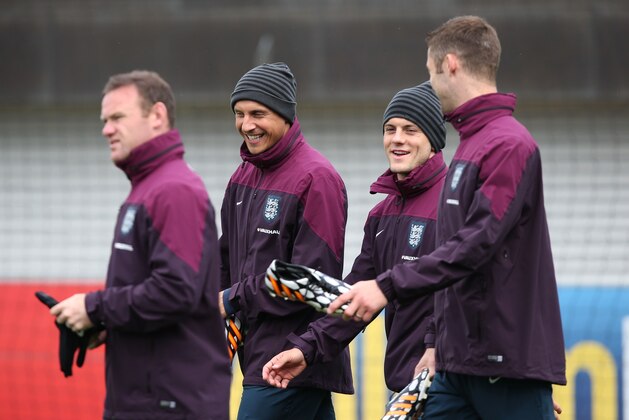 BURTON-UPON-TRENT, ENGLAND - MAY 27:  Phil Jagielka and Jack Wilshere share a joke during a training session at St Georges Park on May 27, 2014 in Burton-upon-Trent, England. (Photo by Jan Kruger/Getty Images)