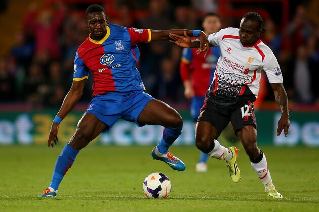 LONDON, ENGLAND - MAY 05:  Yannick Bolasie of Crystal Palace and Victor Moses of Liverpool compete for the ball during the Barclays Premier League match between Crystal Palace and Liverpool at Selhurst Park on May 5, 2014 in London, England.  (Photo by Clive Rose/Getty Images)