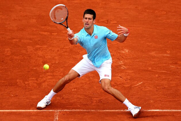 PARIS, FRANCE - MAY 26:  Novak Djokovic of Serbia returns a shot during his men's singles match against Joao Sousa of Portugal on day two of the French Open at Roland Garros on May 26, 2014 in Paris, France.  (Photo by Clive Brunskill/Getty Images)