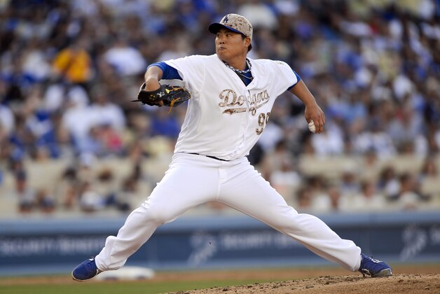 Los Angeles Dodgers starting pitcher Hyun-Jin Ryu throws in the fourth inning of a baseball game against the Cincinnati Reds, Monday, May 26, 2014, in Los Angeles. (AP Photo/Gus Ruelas)