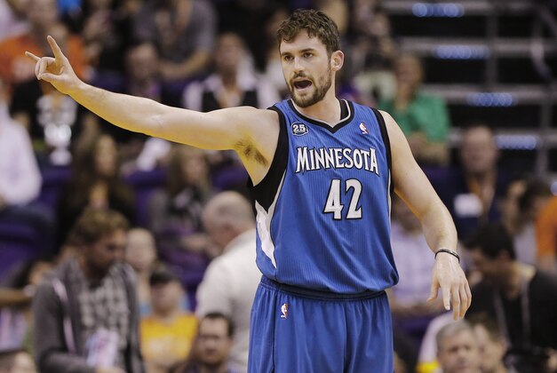 Minnesota Timberwolves forward Kevin Love (42) calls a play against the Phoneix Suns during the first half of an NBA basketball game, Tuesday, Feb. 25, 2014, in Phoenix. (AP Photo/Matt York)