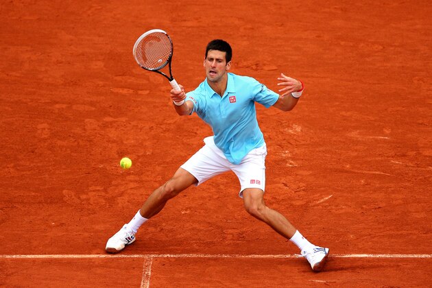 PARIS, FRANCE - MAY 26:  Novak Djokovic of Serbia returns a shot during his men's singles match against Joao Sousa of Portugal on day two of the French Open at Roland Garros on May 26, 2014 in Paris, France.  (Photo by Clive Brunskill/Getty Images)