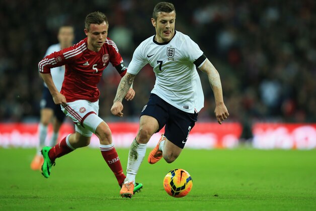 LONDON, ENGLAND - MARCH 05:  Jack Wilshere of England gets away from Peter Ankersen of Denmark during the International Friendly match between England and Denmark at Wembley Stadium on March 5, 2014 in London, England.  (Photo by Richard Heathcote/Getty Images)