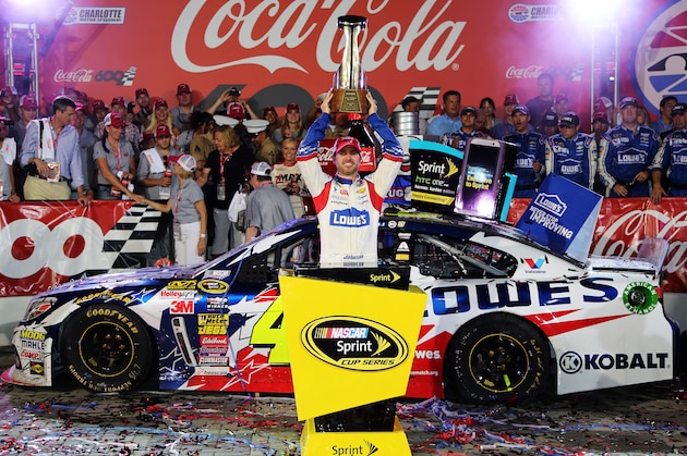 CHARLOTTE, NC - MAY 25:  Jimmie Johnson, driver of the #48 Lowe's Patriotic Chevrolet, poses in victory lane after winning the NASCAR Sprint Cup Series Coca-Cola 600 at Charlotte Motor Speedway on May 25, 2014 in Charlotte, North Carolina.  (Photo by Jerry Markland/Getty Images)