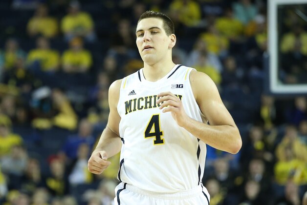 ANN ARBOR, MI - NOVEMBER 29:  Mitch McGary #4 of the Michigan Wolverines runs down the court in his first home game of the season during the second half of the game against Coppin State Eagles at Crisler Center on November 29, 2013 in Ann Arbor, Michigan. Michigan Defeated Coppin State 87-45. (Photo by Leon Halip/Getty Images)