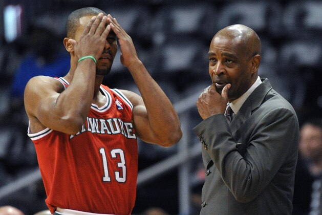 Milwaukee Bucks coach Larry Drew, right, calls in a play to Ramon Sessions (13) in the first half of an NBA basketball game against the Atlanta Hawks on Thursday, March 13, 2014, in Atlanta. (AP Photo/David Tulis)