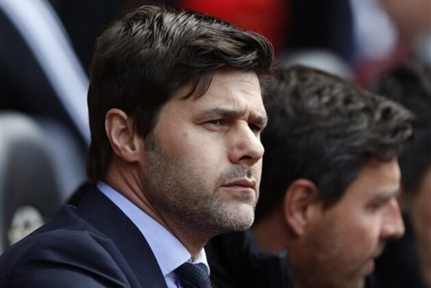 FILE - In this Sunday, May 11, 2014, file photo, Southampton's manager Mauricio Pochettino looks on from the dugout before the start of their English Premier League soccer match against Manchester United at St Mary's stadium, Southampton, England.  Tottenham has hired Mauricio Pochettino as the club's new manager on a five-year contract, with the former Argentina defender making the move from fellow Premier League side Southampton. (AP Photo/Sang Tan, File)