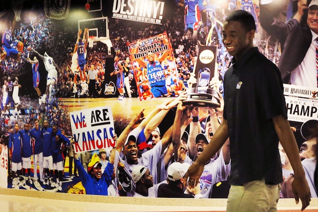 Kansas freshman NCAA college basketball player Andrew Wiggins leaves a news conference at the University of Kansas in Lawrence, Kan., Monday, March 31, 2014. Wiggins announced he would be entering the NBA draft. (AP Photo/Orlin Wagner)