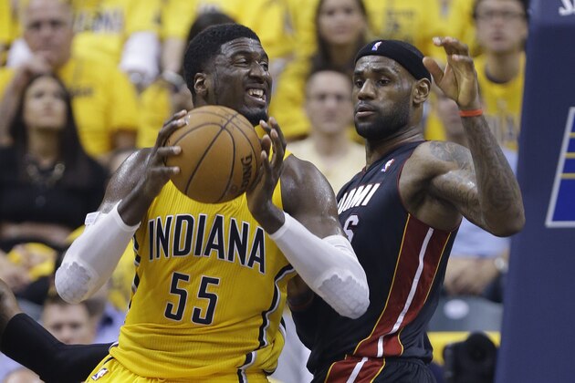 Indiana Pacers' Roy Hibbert is defended by Miami Heat's LeBron James during the first half of Game 2 of the NBA basketball Eastern Conference finals in Indianapolis, Tuesday, May 20, 2014. (AP Photo/Michael Conroy)
