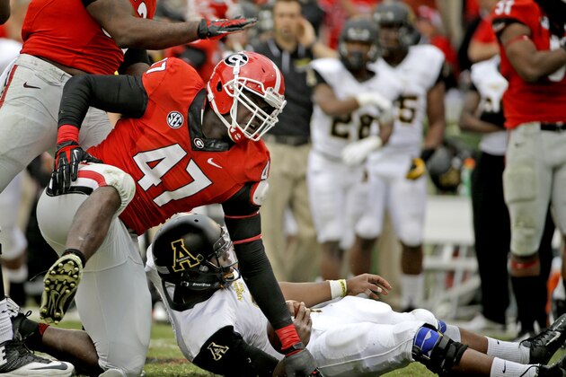 Georgia's Ray Drew, left, gets up after tackling Appalachian State quarterback Kameron Bryant, right, in the third quarter of an NCAA college football game, Saturday, Nov. 9, 2013, in Athens, Ga. (AP Photo/David Goldman)