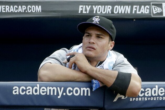 Colorado Rockies' Nolan Arenado stands in the dugout with a splint on his finger during a baseball game against the Atlanta Braves, Saturday, May 24, 2014, in Atlanta. The Rockies placed Arenado on the 15-day disabled list Saturday, one day after he broke his left middle finger on a head-first slide into second base. (AP Photo/David Goldman)