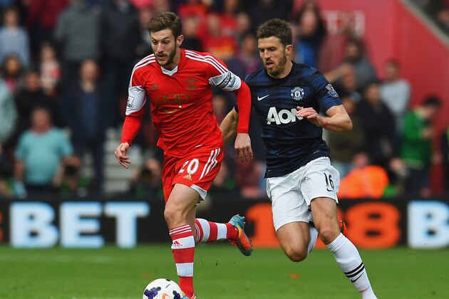 SOUTHAMPTON, ENGLAND - MAY 11:  (L-R) Adam Lallana of Southampton holds off Michael Carrick of Manchester United during the Barclays Premier League match between Southampton and Manchester United at St Mary's Stadium on May 11, 2014 in Southampton, England.  (Photo by Mike Hewitt/Getty Images)
