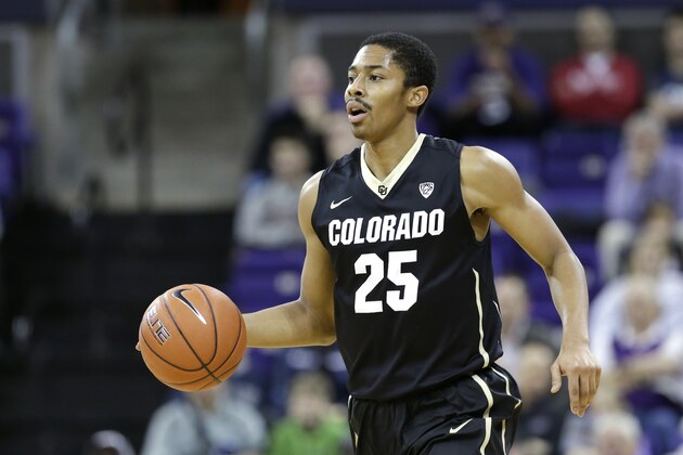 Spencer Dinwiddie dribbles up court against Washington in the first half of an NCAA men's basketball game Sunday, Jan. 12, 2014, in Seattle. (AP Photo/Elaine Thompson)