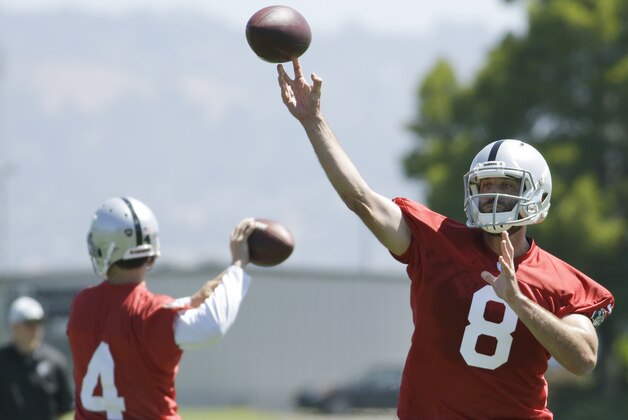 Oakland Raiders quarterbacks Matt Schaub (8) and Derek Carr, left, throw passes during an NFL football minicamp Tuesday, May 27, 2014, in Alameda, Calif. (AP Photo/Ben Margot)