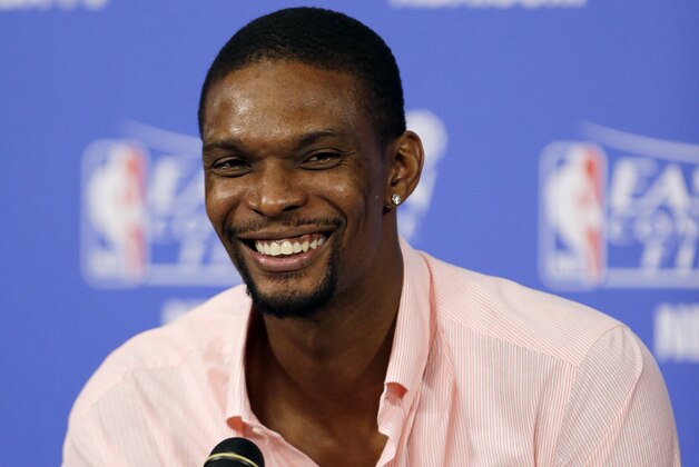 Miami Heat center Chris Bosh smiles during a post-game news conference after Game 4 in the NBA basketball Eastern Conference finals playoff series, Tuesday, May 27, 2014, in Miami. The Heat won 102-90. Bosh had 25 points. (AP Photo/Wilfredo Lee)