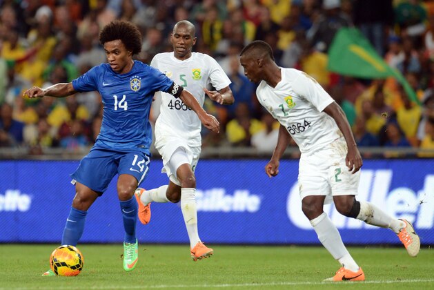 JOHANNESBURG, SOUTH AFRICA - MARCH 05: Willian of Brazil, Anele Ngcongca and Siyanda Xulu during the International Friendly match between South Africa and Brazil at FNB Stadium on March 05, 2014 in Johannesburg, South Africa. (Photo by Lefty Shivambu/Gallo Images/Getty Images)