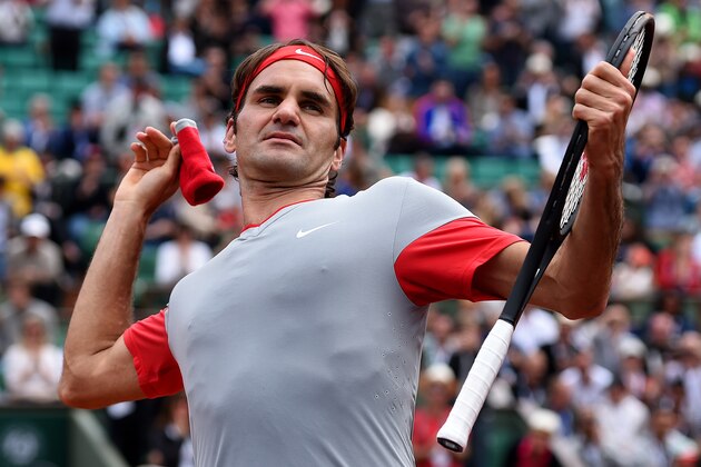 PARIS, FRANCE - MAY 25:  Roger Federer of Switzerland throws his sweatband into the crowd as he celebrates victory in his men's singles match against Lukas Lacko of Slovakia on day one of the French Open at Roland Garros on May 25, 2014 in Paris, France.  (Photo by Matthias Hangst/Getty Images)
