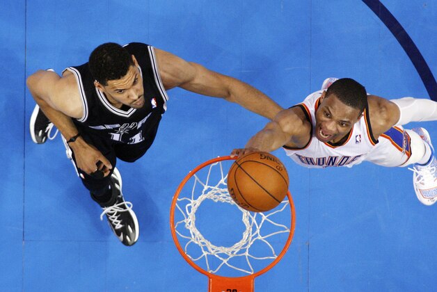 Oklahoma City Thunder guard Russell Westbrook, right, shoots in front of San Antonio Spurs forward Jeff Ayres (11) in the fourth quarter of Game 3 of an NBA basketball playoff series in the Western Conference finals, Sunday, May 25, 2014, in Oklahoma City. Oklahoma City won 106-97. (AP Photo/Sue Ogrocki)