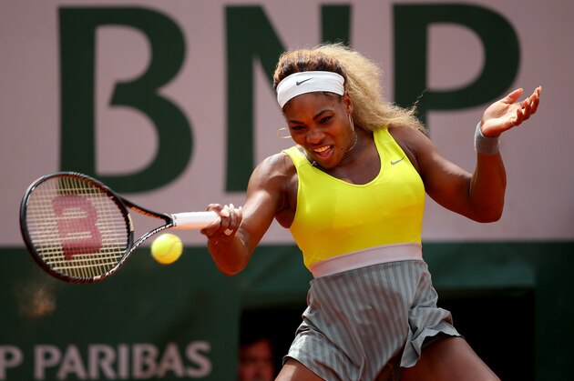 PARIS, FRANCE - MAY 28:  Serena Williams of the United States returns a shot during her women's singles match against Garbine Muguruza of Spain on day four of the French Open at Roland Garros on May 28, 2014 in Paris, France.  (Photo by Clive Brunskill/Getty Images)