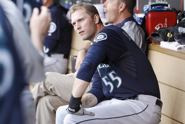 Seattle Mariners right fielder Michael Saunders (55) sits in the dugout during the first inning of a baseball game against the Minnesota Twins in Minneapolis, Saturday, May 17, 2014. (AP Photo/Ann Heisenfelt)