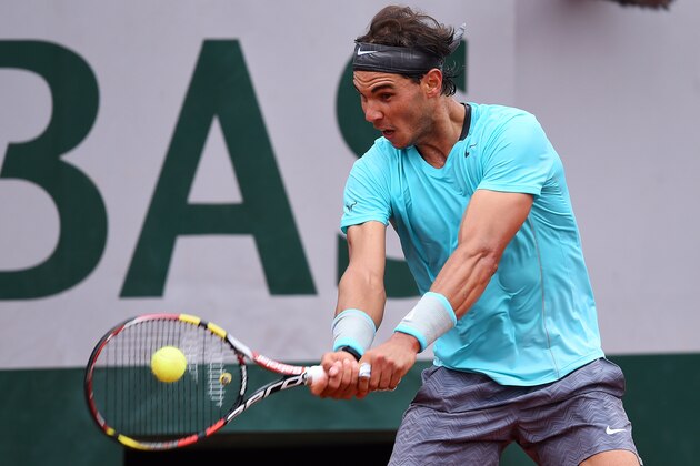 PARIS, FRANCE - MAY 26:  Rafael Nadal of Spain returns a shot during his men's singles match against Robby Ginepri of the United States on day two of the French Open at Roland Garros on May 26, 2014 in Paris, France.  (Photo by Matthias Hangst/Getty Images)
