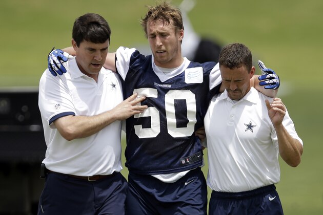Dallas Cowboys linebacker Sean Lee is helped off the field by head athletic trainer Jim Maurer, left, and associate athletic trainer Britt Brown, right, after suffering an unknown left knee injury during an NFL football organized team activity, Tuesday, May 27, 2014, in Irving, Texas. (AP Photo/Tony Gutierrez) Dallas Cowboys linebacker Sean Lee is helped off the field by head athletic trainer Jim Maurer, left, and associate athletic trainer Britt Brown, right, after suffering an unknown left knee injury during an NFL football organized team activity, Tuesday, May 27, 2014, in Irving, Texas. (AP Photo/Tony Gutierrez)
