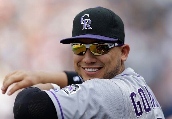ATLANTA, GA - MAY 24:  Outfielder Carlos Gonzalez #5 of the Colorado Rockies laughs in the dugout during the game against the Atlanta Braves  at Turner Field on May 24, 2014 in Atlanta, Georgia.  (Photo by Mike Zarrilli/Getty Images)