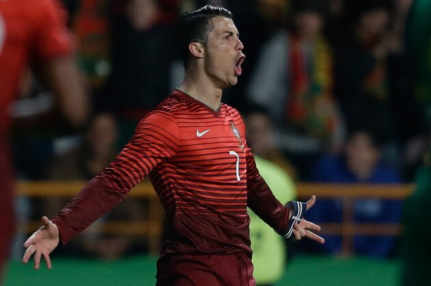 Portugal's Cristiano Ronaldo celebrates after scoring the opening goal during their friendly soccer match with Cameroon Wednesday, March 5 2014, in Leiria, Portugal. The game is part of both teams' preparation for the World Cup in Brazil. (AP Photo/Armando Franca)