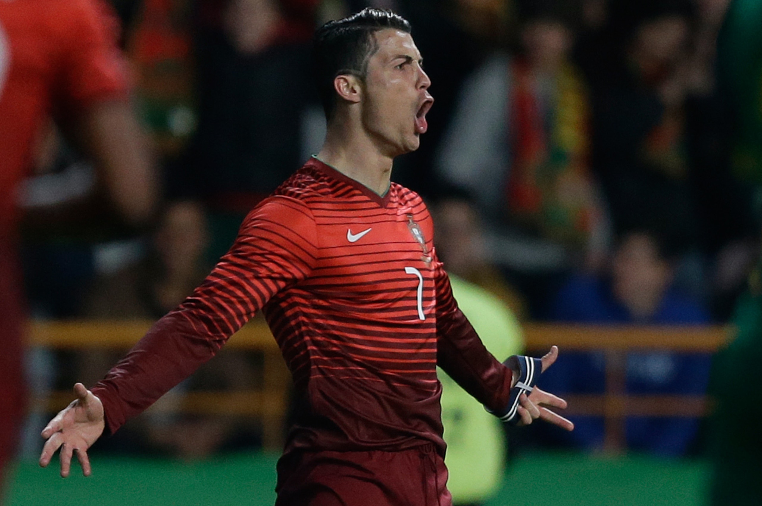 Portugal's Cristiano Ronaldo celebrates after scoring the opening goal during their friendly soccer match with Cameroon Wednesday, March 5 2014, in Leiria, Portugal. The game is part of both teams' preparation for the World Cup in Brazil. (AP Photo/Armando Franca)