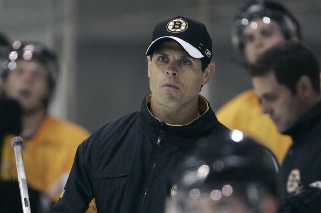 Boston Bruins director of player development Don Sweeney, center, watches play during a hockey team development camp in Wilmington, Mass. Monday, July 9, 2007.(AP Photo/Charles Krupa)