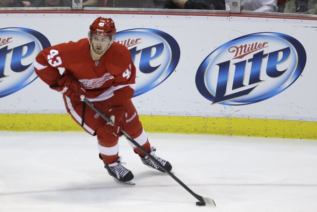 Detroit Red Wings center Darren Helm (43) controls the puck during the third period of an NHL hockey game against the Washington Capitals in Detroit, Friday, Jan. 31, 2014. (AP Photo/Carlos Osorio)