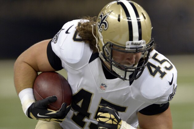 New Orleans Saints fullback Jed Collins (45) carries in the first half of an NFL football game against the Arizona Cardinals in New Orleans, Sunday, Sept. 22, 2013. (AP Photo/Bill Feig)