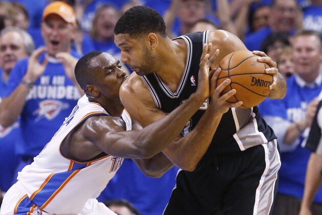 Oklahoma City Thunder forward Serge Ibaka (9) reaches in to try and take the ball away from San Antonio Spurs forward Tim Duncan (21) in the second quarter of Game 4 of the Western Conference finals NBA basketball playoff series in Oklahoma City, Tuesday, May 27, 2014.  (AP Photo/Sue Ogrocki)