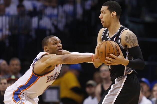 Oklahoma City Thunder guard Russell Westbrook (0) reaches to knock the ball away from San Antonio Spurs guard Danny Green (4) in the second quarter of Game 4 of the Western Conference finals NBA basketball playoff series in Oklahoma City, Tuesday, May 27, 2014.  (AP Photo/Sue Ogrocki)