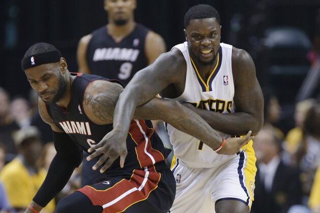 Indiana Pacers guard Lance Stephenson (1) and Miami Heat forward LeBron James (6) scramble for a loose ball during the second half of Game 5 of the NBA basketball Eastern Conference finals in Indianapolis, Wednesday, May 28, 2014. (AP Photo/Michael Conroy)
