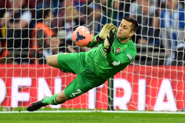 LONDON, ENGLAND - APRIL 12:  Lukasz Fabianski of Arsenal saves a penalty during the shootout during the FA Cup Semi-Final match between Wigan Athletic and Arsenal at Wembley Stadium on April 12, 2014 in London, England.  (Photo by Mike Hewitt/Getty Images)