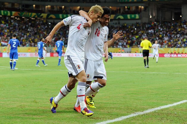 RECIFE, BRAZIL - JUNE 19:  Keisuke Honda of Japan is congratulated by his team-mate Shinji Kagawa (R) after scoring the opening goal from a penalty during the FIFA Confederations Cup Brazil 2013 Group A match between Italy and Japan at Arena Pernambuco on June 19, 2013 in Recife, Brazil.  (Photo by Claudio Villa/Getty Images)