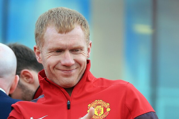 MANCHESTER, ENGLAND - MAY 13: Manchester United's Paul Scholes acknowledges the fans from an open-top bus at the start of their Barclays Premier League Trophy Parade through Manchester on May 13, 2013 in Manchester, England.  (Photo by Christopher Furlong/Getty Images)