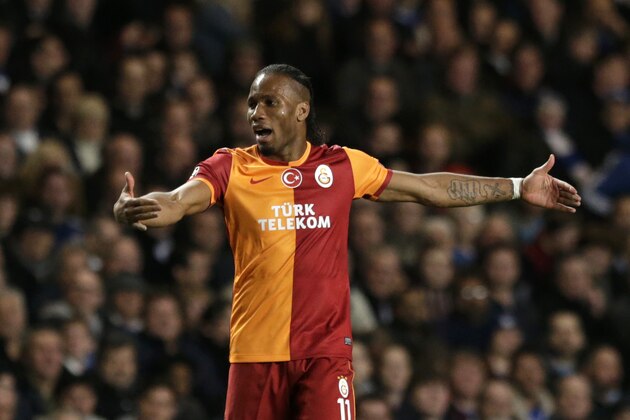 Galatasaray's Didier Drogba reacts to referee Felix Brych showing him a yellow card during the Champions League last 16 second leg soccer match between Chelsea and Galatasaray at Stamford Bridge stadium in London, Tuesday, March 18, 2014. (AP Photo/Matt Dunham)