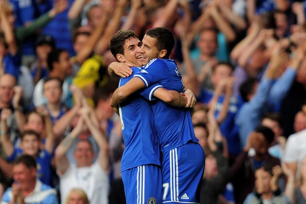 LONDON, ENGLAND - AUGUST 21:  Eden Hazard (R) of Chelsea is congratulated by teammate Oscar (L) after scoring the opening goal during the Barclays Premier League match between Chelsea and Aston Villa at Stamford Bridge on August 21, 2013 in London, England.  (Photo by Jamie McDonald/Getty Images)