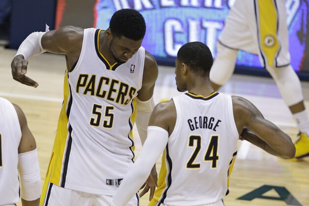 Indiana Pacers' Roy Hibbert and Paul George celebrate after George hit a shot as time expired to end the third quarter of Game 5 of the Eastern Conference finals NBA basketball playoff series against the Miami Heat on Wednesday, May 28, 2014, in Indianapolis. (AP Photo/Darron Cummings)