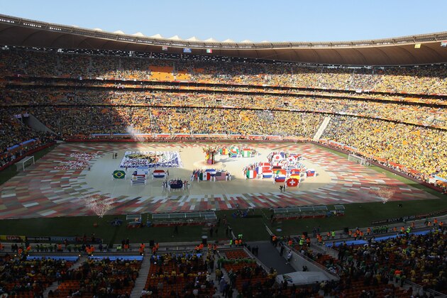 JOHANNESBURG, SOUTH AFRICA - JUNE 11:  Performers display the flags of all the teams competing during the Opening Ceremony ahead of the 2010 FIFA World Cup South Africa Group A match between South Africa and Mexico at Soccer City Stadium on June 11, 2010 in Johannesburg, South Africa.  (Photo by David Cannon/Getty Images)