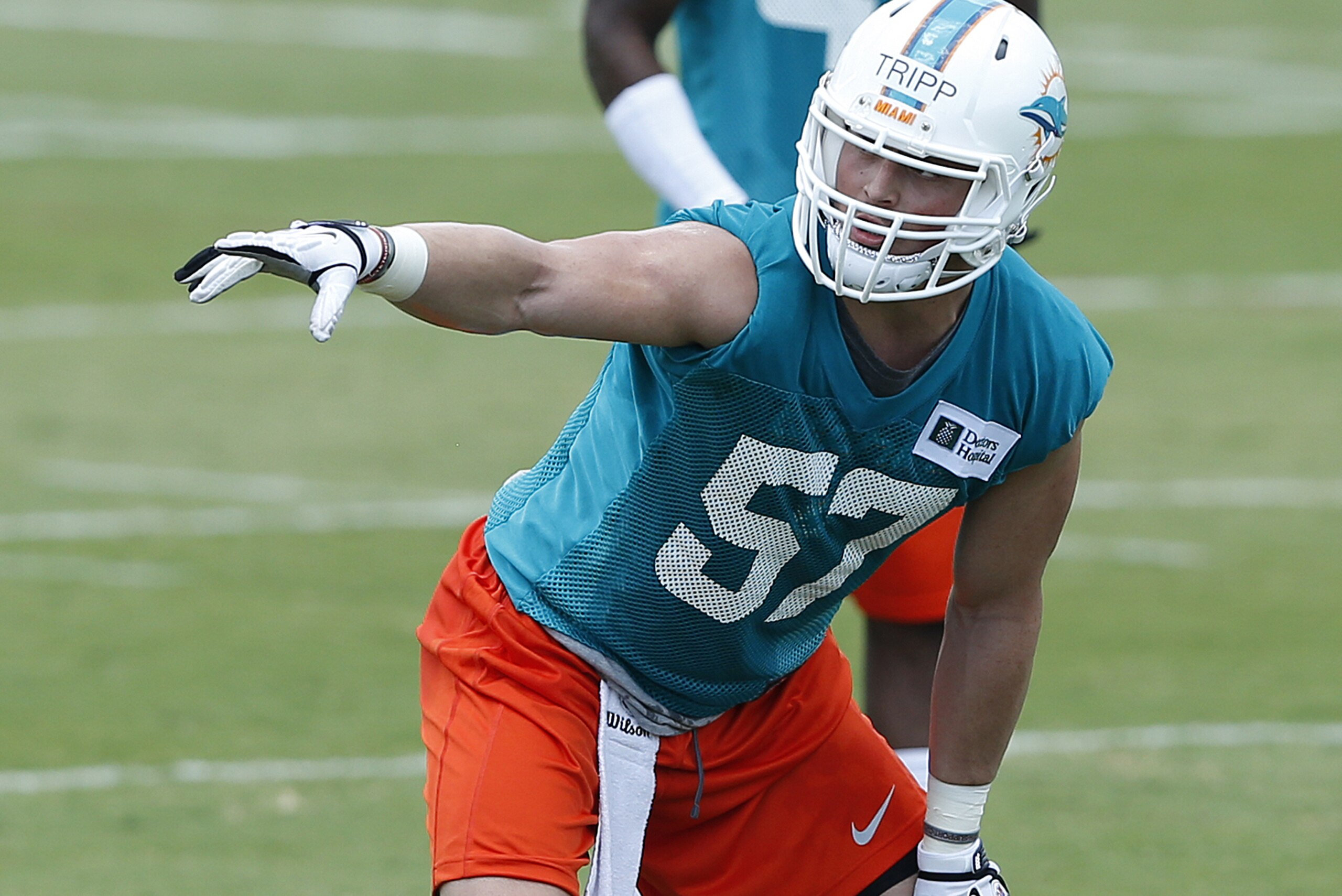 DAVIE, FL - MAY 23: Jordan Tripp #57 of the Miami Dolphins participates in drills during the rookie minicamp on May 23, 2014 at the Miami Dolphins training facility in Davie, Florida. (Photo by Joel Auerbach/Getty Images) DAVIE, FL - MAY 23: Jordan Tripp #57 of the Miami Dolphins participates in drills during the rookie minicamp on May 23, 2014 at the Miami Dolphins training facility in Davie, Florida. (Photo by Joel Auerbach/Getty Images)