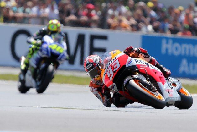 Spanish MotoGP rider Marc Marquez of the Repsol Honda Team leads the race ahead of Italian MotoGP rider Valentino Rossi of Movistar Yamaha Team, left, during the MotoGP World Championship race at the Bugatti race track in Le Mans, western France, Sunday, May 18, 2014. (AP Photo/David Vincent)